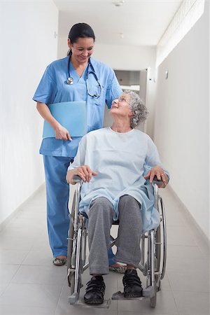 simsearch:400-07337135,k - Elderly patient in a wheelchair looking at a nurse in hospital ward Stock Photo - Budget Royalty-Free & Subscription, Code: 400-06734417