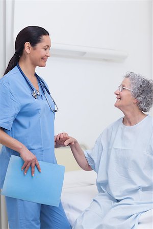 Elderly patient holding the hand of a nurse in hospital ward Stock Photo - Budget Royalty-Free & Subscription, Code: 400-06734434