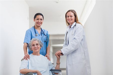 simsearch:400-07337135,k - Patient in corridor holding hand of a doctor in hospital ward Stock Photo - Budget Royalty-Free & Subscription, Code: 400-06734430