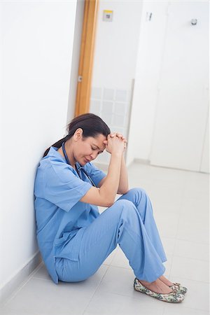 simsearch:400-06734621,k - Sad nurse sitting on the floor in hospital ward Stock Photo - Budget Royalty-Free & Subscription, Code: 400-06734454