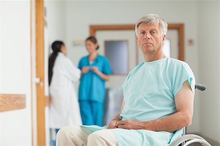 patients and doctors looking at camera hallway - Male patient in a wheelchair looking at camera in hospital corridor Stock Photo - Budget Royalty-Free & Subscription, Code: 400-06734504