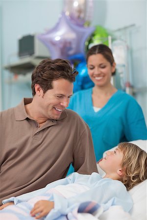 father sick child - Child lying on a medical bed looking at his father in hospital ward Stock Photo - Budget Royalty-Free & Subscription, Code: 400-06734506