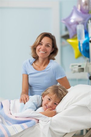 Child lying on a bed next to his mother in hospital ward Stock Photo - Budget Royalty-Free & Subscription, Code: 400-06734513