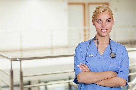 Blonde nurse looking at camera with arms crossed in hospital corridor Stock Photo - Budget Royalty-Free & Subscription, Code: 400-06734553