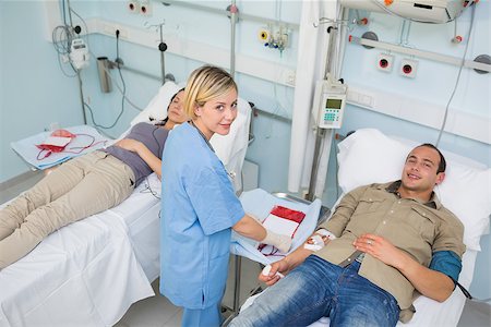 simsearch:400-06734658,k - Transfused patients and a nurse looking at camera in hospital ward Stock Photo - Budget Royalty-Free & Subscription, Code: 400-06734602