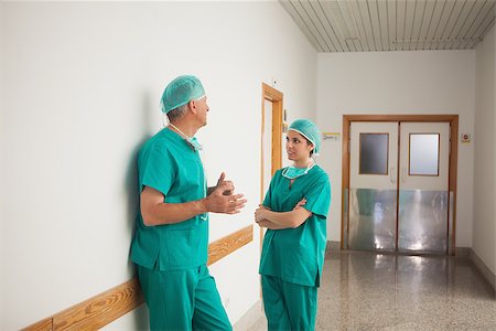 simsearch:400-06734621,k - Surgeons talking in the corridor in a hospital Stock Photo - Budget Royalty-Free & Subscription, Code: 400-06734623