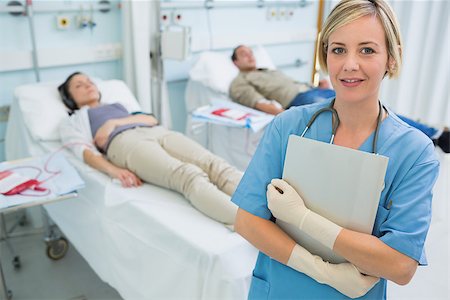 simsearch:400-06734658,k - Nurse standing next to transfused patients in hospital ward Stock Photo - Budget Royalty-Free & Subscription, Code: 400-06734658