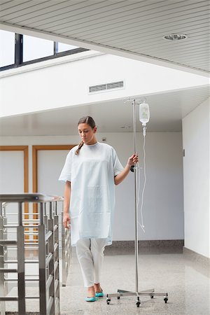 patient walking hospital halls - Female patient walking while holding a drip stand in hospital ward Foto de stock - Super Valor sin royalties y Suscripción, Código: 400-06734673