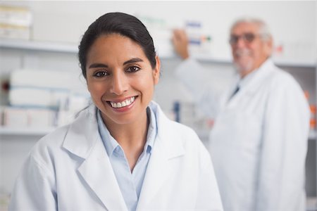 pharmacist with senior - Smiling pharmacist looking at camera in hospital Stock Photo - Budget Royalty-Free & Subscription, Code: 400-06734719