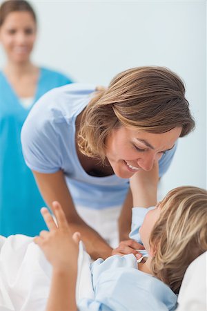 Child on a medical bed looking his mother in hospital ward Stock Photo - Budget Royalty-Free & Subscription, Code: 400-06734712