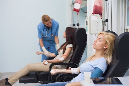 simsearch:400-06734658,k - Nurse taking care of a blood donor in hospital ward Stock Photo - Budget Royalty-Free & Subscription, Code: 400-06734843