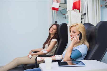 simsearch:400-06734658,k - Patient receiving a blood transfusion while calling in hospital ward Stock Photo - Budget Royalty-Free & Subscription, Code: 400-06734855