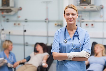 simsearch:400-06734658,k - Nurse standing with arms crossed next to patients in hospital ward Stock Photo - Budget Royalty-Free & Subscription, Code: 400-06734865