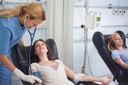 simsearch:400-06734658,k - Nurse using a stethoscope on the forearm of a patient in hospital ward Stock Photo - Budget Royalty-Free & Subscription, Code: 400-06734868