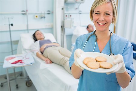 female nurse male patient injection - Nurse holding a plate of biscuits in hospital ward Stock Photo - Budget Royalty-Free & Subscription, Code: 400-06734887