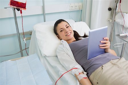 photo of patient in hospital in usa - Smiling transfused holding a tablet computer in hospital ward Stock Photo - Budget Royalty-Free & Subscription, Code: 400-06734976