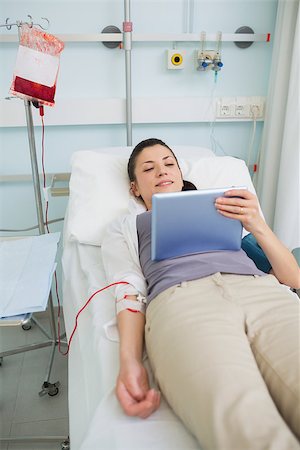 donation - Female transfused patient holding a tablet computer in hospital ward Stock Photo - Budget Royalty-Free & Subscription, Code: 400-06734978
