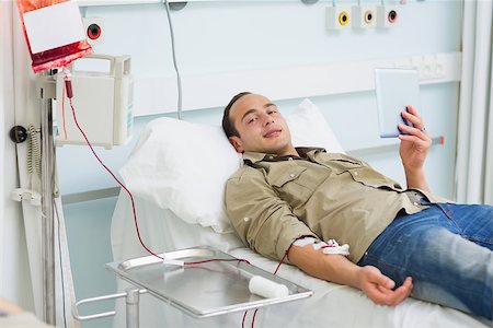 donation - Transfused patient holding a tablet computer in hospital ward Stock Photo - Budget Royalty-Free & Subscription, Code: 400-06734970