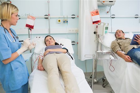 simsearch:400-06734658,k - Two transfused patients looking at a nurse in hospital ward Stock Photo - Budget Royalty-Free & Subscription, Code: 400-06734972