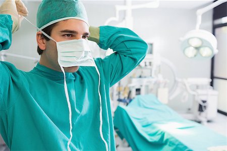 Surgeon putting his mask in an operating theatre Stock Photo - Budget Royalty-Free & Subscription, Code: 400-06735520