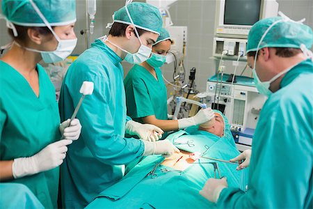 simsearch:400-06735487,k - Concentrated surgeons in an operating theatre Fotografie stock - Microstock e Abbonamento, Codice: 400-06735564