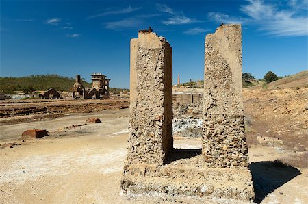 Damaged buildings in Sao Domingos Mine, a deserted open-pit mine in Mertola, Alentejo, Portugal. This site is one of the volcanogenic massive sulfide ore deposits in the Iberian Pyrite Belt, which extends from the southern Portugal into Spain Stock Photo - Budget Royalty-Free & Subscription, Code: 400-06735834