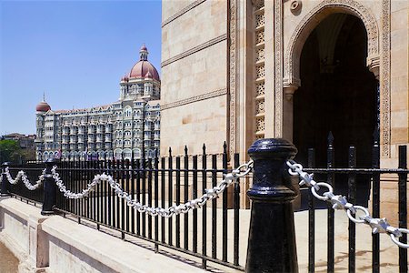 Landscape of the Gateway of India, its black and silver painted railings with a cameo view of the Taj Hotel with an angled view of an archway Stock Photo - Budget Royalty-Free & Subscription, Code: 400-06735847