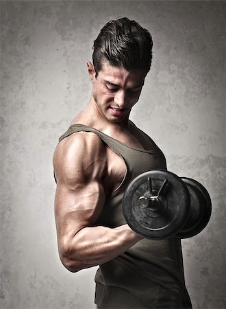 Muscular man raising a dumbbell Stock Photo - Budget Royalty-Free & Subscription, Code: 400-06735877