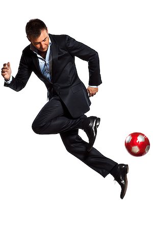 soccer dynamic - one caucasian business man playing juggling soccer ball in studio isolated on white background Stock Photo - Budget Royalty-Free & Subscription, Code: 400-06737816