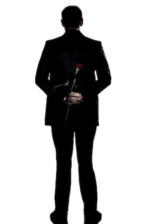 one caucasian backside man holding a rose flower  full length silhouette in studio isolated white background Stock Photo - Budget Royalty-Free & Subscription, Code: 400-06737821