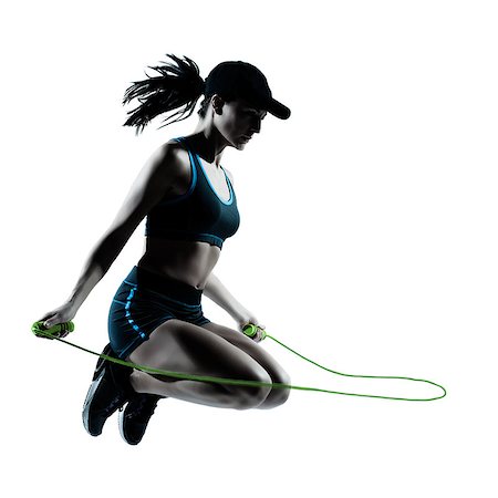 sprinterin - one caucasian woman runner jogger jumping rope in silhouette studio isolated on white background Stockbilder - Microstock & Abonnement, Bildnummer: 400-06738024