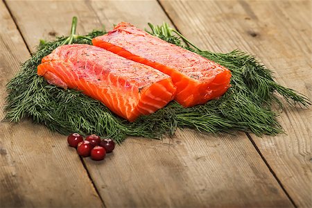 Two pieces of salty salmon over the greenery on the table with some cranberry Photographie de stock - Aubaine LD & Abonnement, Code: 400-06739192