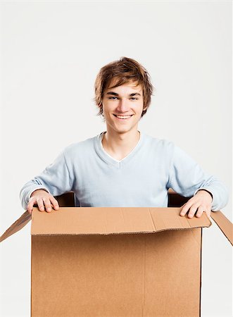 Portrait of a handsome young man inside a cardbox Stock Photo - Budget Royalty-Free & Subscription, Code: 400-06739934