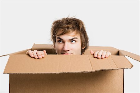 Portrait of a handsome young man inside a cardbox Stock Photo - Budget Royalty-Free & Subscription, Code: 400-06739933