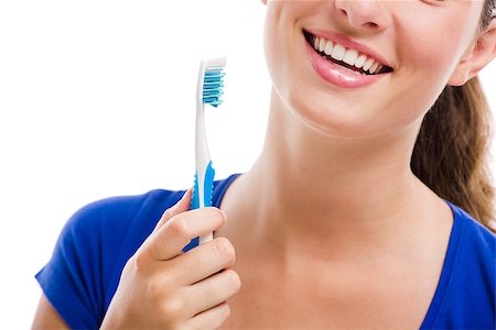 Beautiful woman with a great smile holding toothbrush, isolated over a white background Stock Photo - Budget Royalty-Free & Subscription, Code: 400-06739960
