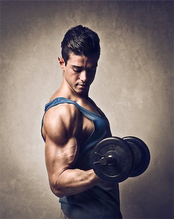 Man raising a dumbbell with his muscular right arm Stock Photo - Budget Royalty-Free & Subscription, Code: 400-06733526