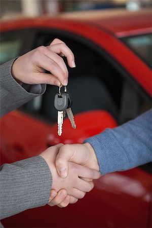 People shaking hands while holding keys in a car shop Stock Photo - Budget Royalty-Free & Subscription, Code: 400-06733658