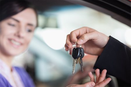 Woman in a car receiving keys from a car dealer Stock Photo - Budget Royalty-Free & Subscription, Code: 400-06733684