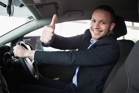 Man driving a car while smiling Stock Photo - Budget Royalty-Free & Subscription, Code: 400-06733698