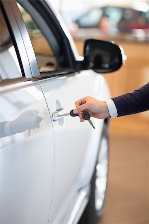 Man inserting a car key in the lock in a garage Stock Photo - Budget Royalty-Free & Subscription, Code: 400-06733899