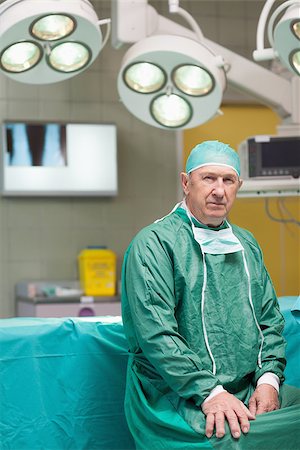 simsearch:400-06734621,k - Serious surgeon looking at camera in operating theatre Stock Photo - Budget Royalty-Free & Subscription, Code: 400-06733959