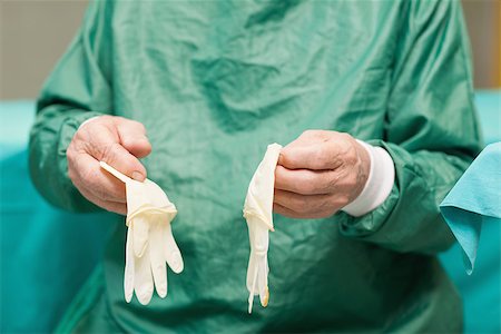 simsearch:400-06734621,k - Surgeon hiolding surgical gloves in a surgical room Stock Photo - Budget Royalty-Free & Subscription, Code: 400-06733967