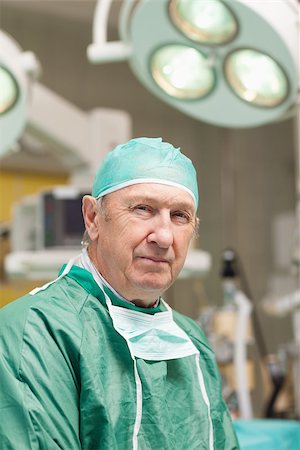 simsearch:400-06734621,k - Close up of a surgeon looking at camera in an operating theatre Stock Photo - Budget Royalty-Free & Subscription, Code: 400-06733961