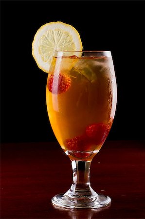 raspberry iced tea garnished with a lemon wheel on a dark bar Stock Photo - Budget Royalty-Free & Subscription, Code: 400-06744535