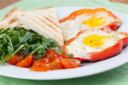 fried egg and pepper - Eggs fired in bell pepper frames with cherry tomatoes and arugula Stock Photo - Budget Royalty-Free & Subscription, Code: 400-06745622