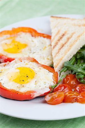 fried egg and pepper - Eggs fired in bell pepper frames with cherry tomatoes and arugula Stock Photo - Budget Royalty-Free & Subscription, Code: 400-06745623