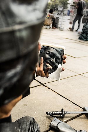 street entertainer - street performer doing makeup before perform Stock Photo - Budget Royalty-Free & Subscription, Code: 400-06745657