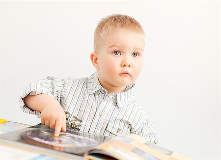 curious baby boy studying with the book Stockbilder - Microstock & Abonnement, Bildnummer: 400-06747547