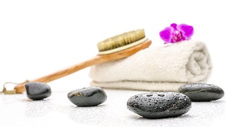 spa decoration - Spa setting with massage stones, brush and a towel. On a white table with water drops. Stock Photo - Budget Royalty-Free & Subscription, Code: 400-06747759