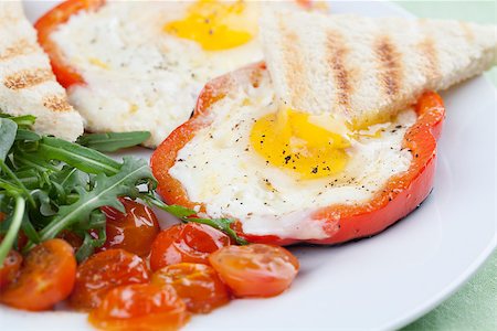 fried egg and pepper - Eggs fired in bell pepper frames with cherry tomatoes and arugula Stock Photo - Budget Royalty-Free & Subscription, Code: 400-06747857